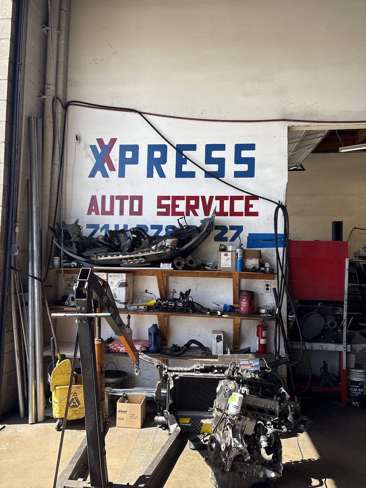The hand-painted Xpress Auto Service sign inside the shop