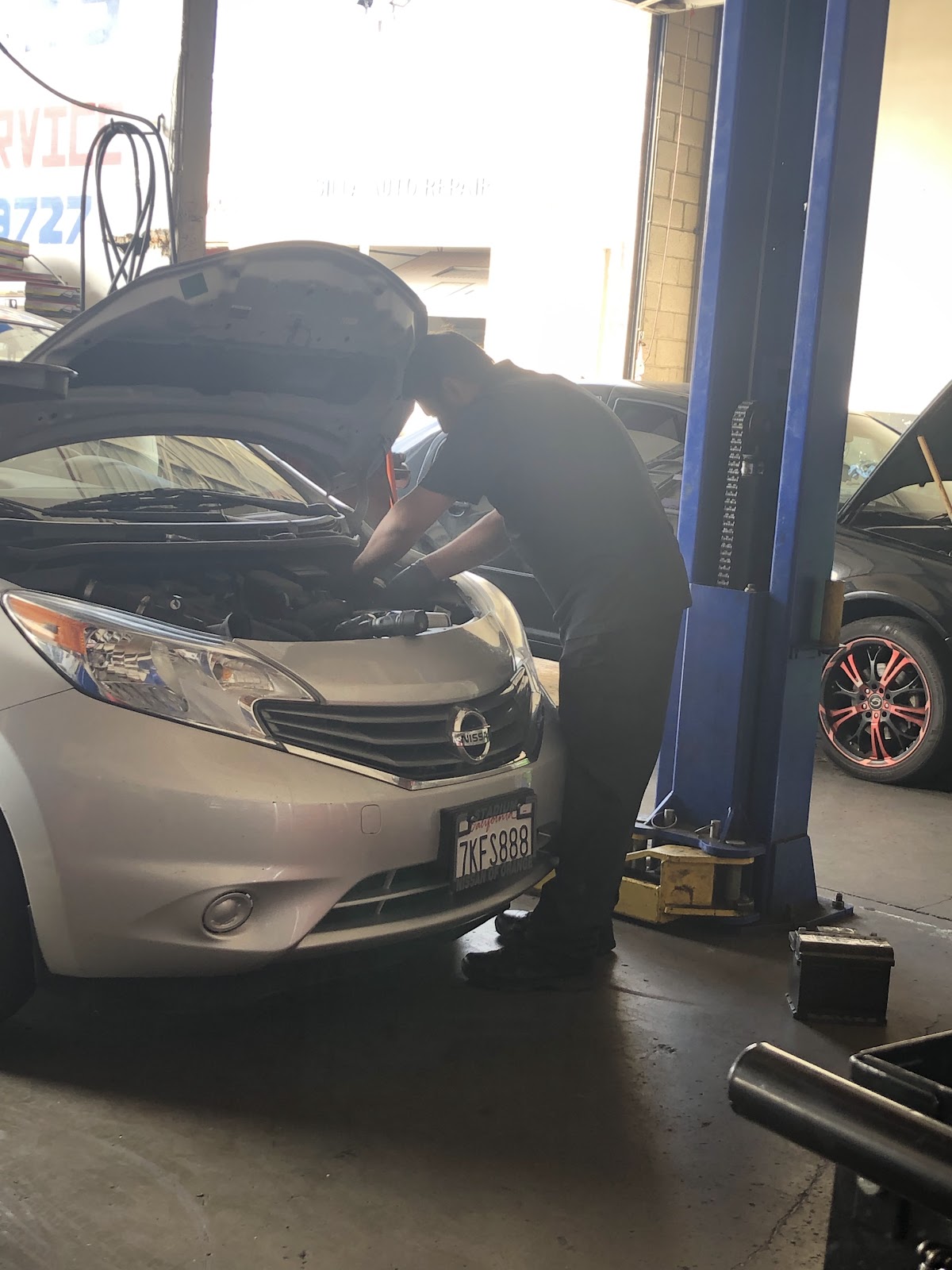 A technician working under the hood